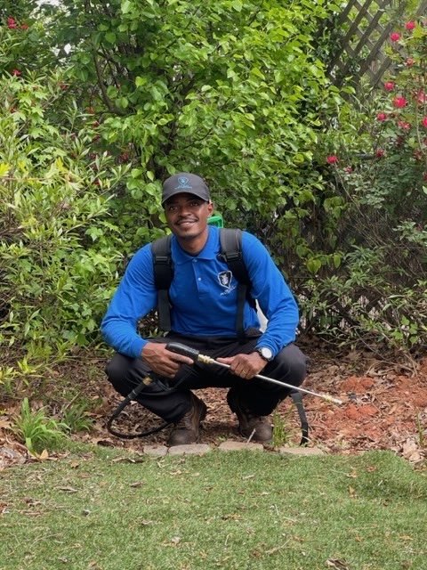 Friendly Allsect technician treating the exterior of an Atlanta home